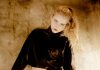 Quiet Polish: Style Habits That Make Any Look Feel More Expensive a woman in a black top and a shiny skirt