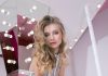 Dressed for the Feeling: Elegant Party Outfit Ideas for Every Mood Elegant woman in jumpsuit poses against a mirrored, lighted background.
