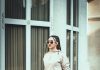 Sidewalk Confidence: Casual Outfit Ideas Inspired by City Style a woman standing on a sidewalk in front of a building