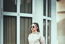 Sidewalk Confidence: Casual Outfit Ideas Inspired by City Style a woman standing on a sidewalk in front of a building