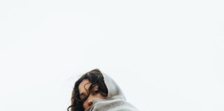Fresh by the Season: Outfit Ideas That Feel Stylish, Easy, and Wearable Woman in trench coat and scarf on stairs