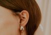 The Finishing Touch: How to Style Statement Bags, Belts, and Jewelry woman wearing silver diamond stud earring