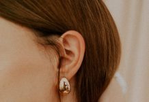 The Finishing Touch: How to Style Statement Bags, Belts, and Jewelry woman wearing silver diamond stud earring