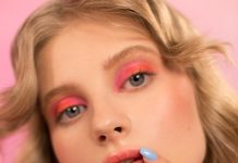 Quiet Confidence: Minimal Outfit Ideas with a Sophisticated Feel Woman with vibrant makeup and pastel nails touching her face.