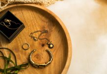Small Details, Strong Style: How to Choose Accessories for Minimal Outfits silver rings on brown wooden round tray