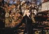 The Art of Looking Polished Without Overdressing woman leaning on black fence