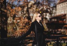 The Art of Looking Polished Without Overdressing woman leaning on black fence